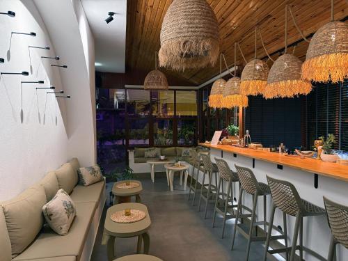 a restaurant with a bar with chairs and tables at Casa Vagabundo Boutique Hotel - Adults Only in Alanya