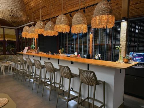 a bar with a row of bar stools at Casa Vagabundo Boutique Hotel - Adults Only in Alanya
