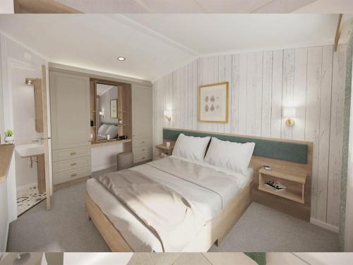 a bedroom with a large bed and a sink at DJD ,Country Style Luxury Lodge, Manor Park Sleeps 4 in Hunstanton