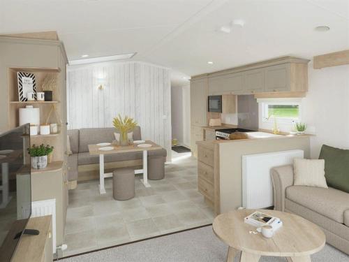 a living room with a couch and a table and a kitchen at DJD ,Country Style Luxury Lodge, Manor Park Sleeps 4 in Hunstanton