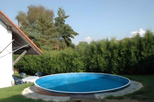 a large blue swimming pool in a yard at Holiday home in Cerna v Posumavi 1908 in Černá v Pošumaví