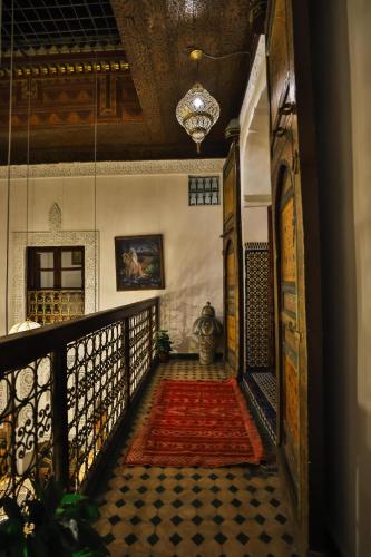 a hallway of a house with a rug on a staircase at Riad Fes Zayna in Fès