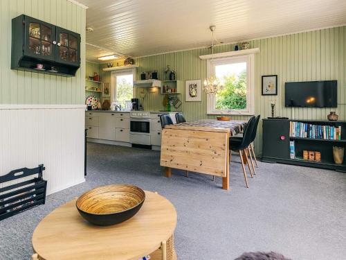a kitchen with a table and a dining room at 2 person holiday home in Thyholm-By Traum in Thyholm