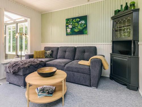 a living room with a couch and a table at 2 person holiday home in Thyholm-By Traum in Thyholm
