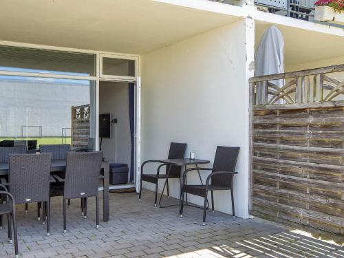 a patio with a table and chairs and a balcony at Norddjurs Holiday Center in Glesborg