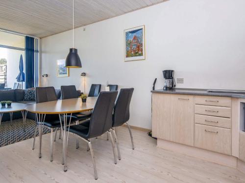 a kitchen and dining room with a table and chairs at Norddjurs Holiday Center in Glesborg