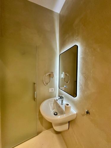a bathroom with a sink and a mirror at Hotel Relax City Center in Tirana