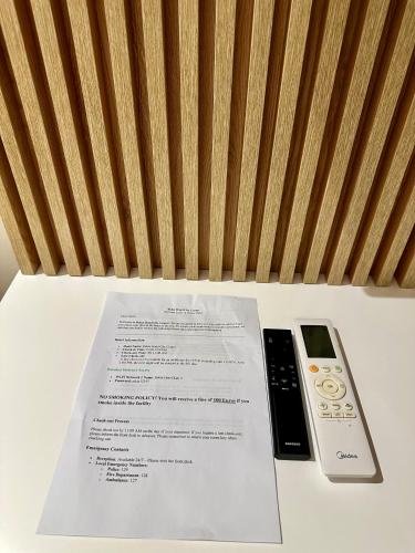 a table with a receipt and a remote control at Hotel Relax City Center in Tirana