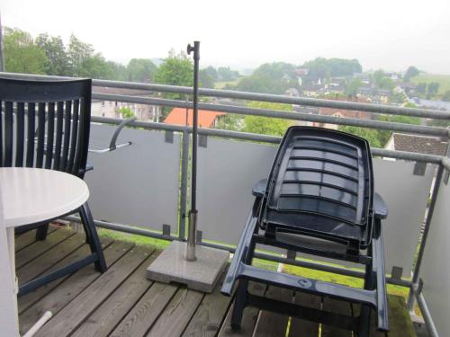 a chair and a table on a balcony at Apartment in Bad Steben - Bayern 50803 in Bad Steben