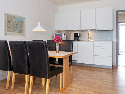 a kitchen and dining room with a table and chairs at Norddjurs Holiday Center in Glesborg
