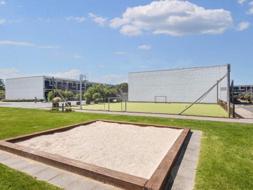 a volley ball court in a field with a building at 4 person holiday home in Glesborg in Glesborg