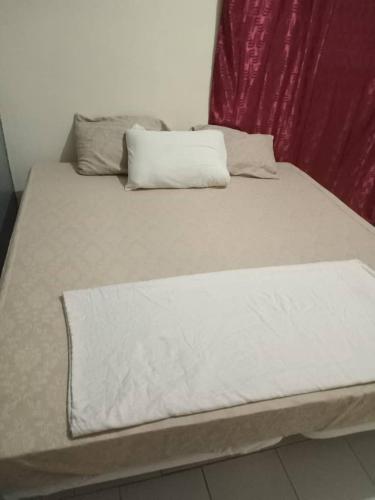 a bed with two pillows on top of it at CHEZ Mamadou et Binetou in Mbour