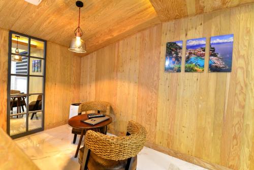 a room with a table and chairs in a room at K Boutique Hotel in Yeosu