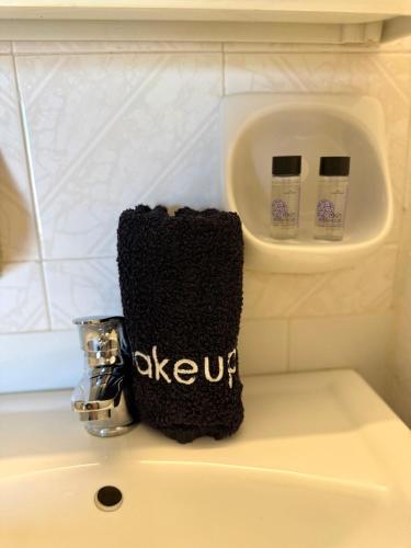 a black towel sitting on top of a sink at Eftihia Studios Paleochora in Palaiochóra