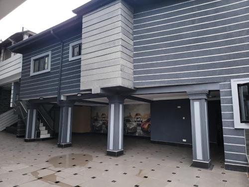 a building with a house on top of it at Caesar's Hotel & Apartment Room #14 in Ikeja