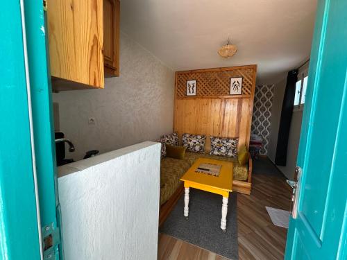 a small living room with a table and a couch at blue studio in Essaouira
