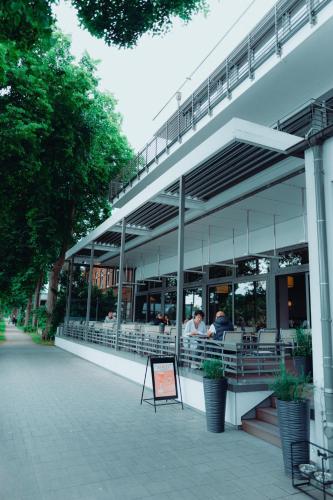 a building with people sitting inside of it at ConventGarten Hotel & Restaurant - am Nord-Ostsee-Kanal in Rendsburg