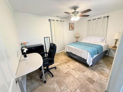 a bedroom with a bed and a desk and a chair at Renovated 2 Bedroom In Durham! Superhost! in Durham