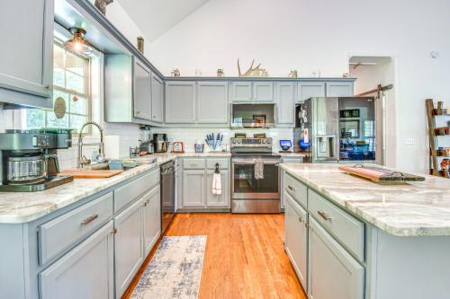 a large kitchen with white cabinets and wooden floors at Hiawassee Cabin Near Lake Chatuge and AT Trailheads in Hiawassee