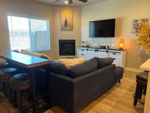 a living room with a couch and a television at The Cabin in Flagstaff