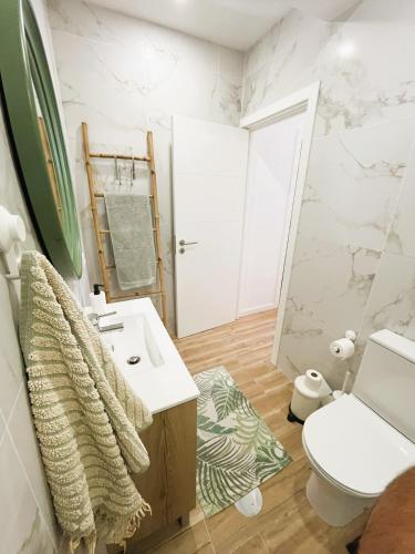 a bathroom with a sink and a toilet at Cortecasa, between the sea and nature in Cortegaça