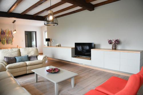 a living room with a couch and a table at Vakantiewoning Nijkenhof in Ninove