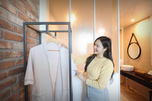 a woman standing in front of a display case at K Boutique Hotel in Yeosu