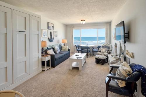 a living room with a couch and chairs and a table at Oceanfront Suite - Top Floor - Pool and Sauna - Sleeps 6 in Lincoln City