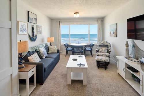 a living room with a couch and a table at Oceanfront Suite - Top Floor - Pool and Sauna - Sleeps 6 in Lincoln City