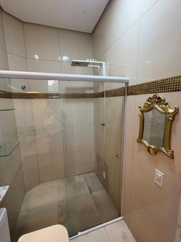 a bathroom with a shower with a toilet and a mirror at Linda casa confortável em Manaus in Manaus