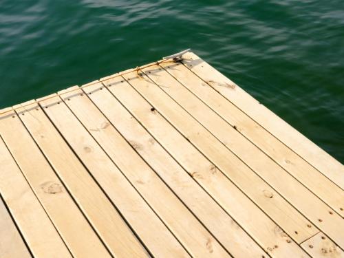 a wooden dock in the middle of the water at La Pausa Hotelbistro in Guatapé