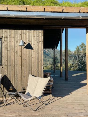 two chairs on a deck with a building at Stylish Cabin In Scenic Surroundings in Skare