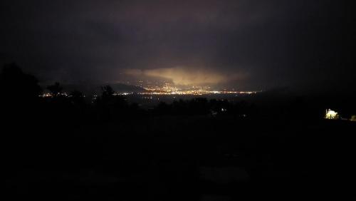 a view of a city at night with lights at Refugio del Sauce Cabaña 1 Tibasosa- Boyacá in Tibasosa