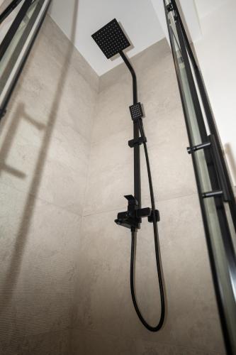 a shower with a shower head in a bathroom at SARAJEVO SUITES No 23 Free parking in Sarajevo