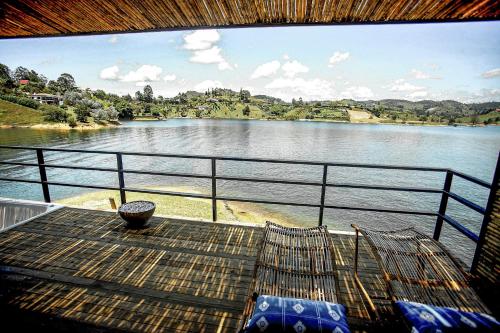 a balcony with a view of a river at La Pausa Hotelbistro in Guatapé