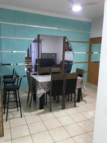 a dining room with a table and chairs and a couch at Casa Aconchego in Triunfo