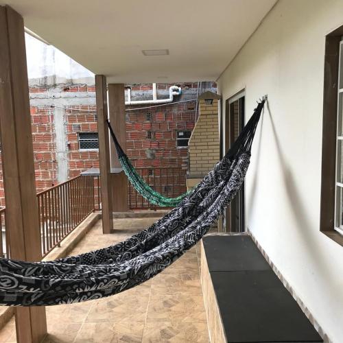 a hammock hanging from a wall in a room at Casa Aconchego in Triunfo