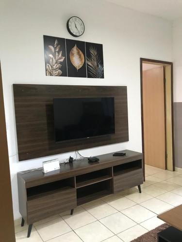 a living room with a flat screen tv on a wall at Casa Aconchego in Triunfo