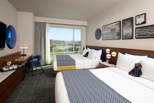 a hotel room with two beds and a window at Hotel Polaris in Colorado Springs