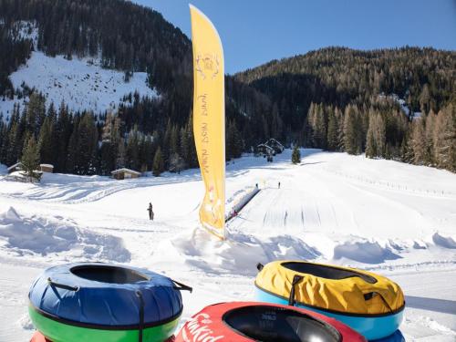 a pair of tubes in the snow on a ski slope at Carmaliva in Innerkrems