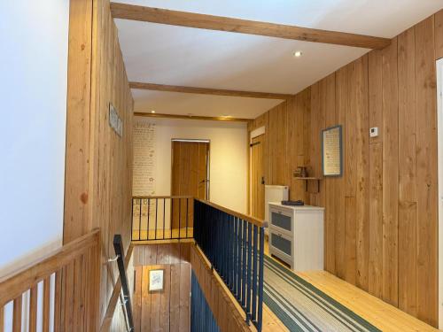a hallway with wood paneled walls and a staircase at Carmaliva in Innerkrems
