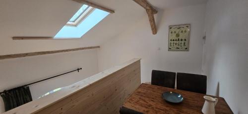 a dining room with a wooden table and a window at Altes Saale Fährhaus in Naumburg