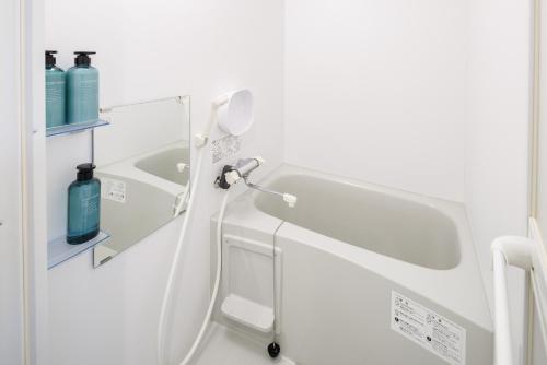 a bathroom with a shower and a sink at Hotel Hs Park Chitose in Chitose