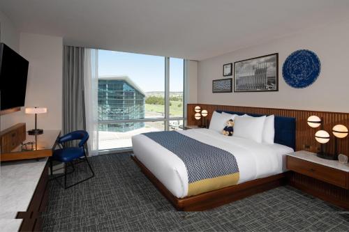 a hotel room with a bed and a large window at Hotel Polaris in Colorado Springs
