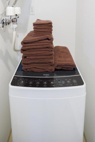a pile of towels sitting on top of a stove at Hotel Hs Park Chitose in Chitose