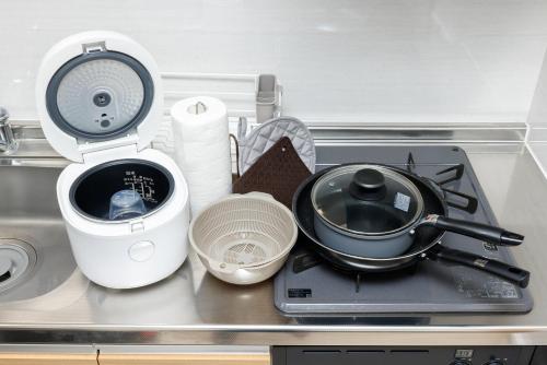 a kitchen counter with a stove with a pot on it at Hotel Hs Park Chitose in Chitose