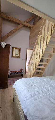 a bedroom with a bed and a staircase at Altes Saale Fährhaus in Naumburg