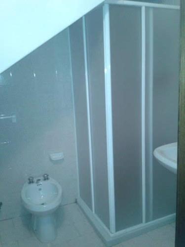 a white bathroom with a toilet and a sink at Casa naanì Mughetto in San Colombano