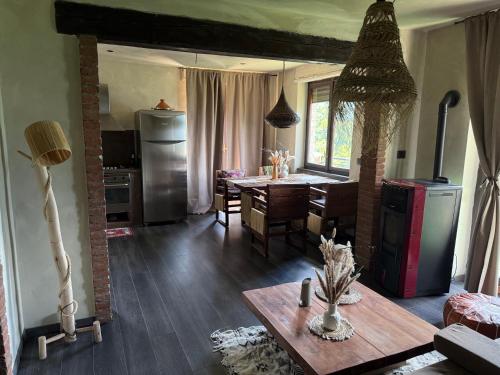 a kitchen and dining room with a table and a dining room at Luxury Relax Idromassaggio in Meana di Susa