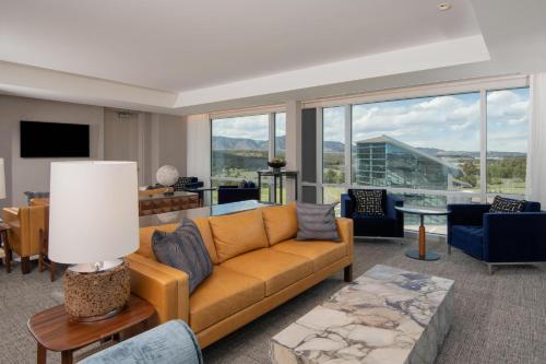 a living room with a couch and a large window at Hotel Polaris in Colorado Springs